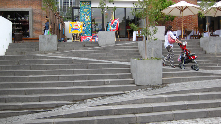 A non-handicap-friendly ramp cuts through a set of stairs